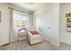 Cozy bedroom with a comfortable chair, side table, and a bright window for natural light at 3567 E 140Th Dr, Thornton, CO 80602