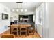 Dining area with hardwood floors, large windows, and views into the living room at 3567 E 140Th Dr, Thornton, CO 80602