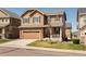Beautiful two-story house with stone accents, a front porch, and a well-manicured lawn at 3567 E 140Th Dr, Thornton, CO 80602