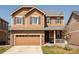 Charming two-story home with stone accents, attached garage, and welcoming front porch at 3567 E 140Th Dr, Thornton, CO 80602
