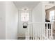Bright hallway features modern lighting and a staircase with white railings at 3567 E 140Th Dr, Thornton, CO 80602