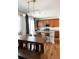 Eat-in kitchen with a wooden dining table, quartz countertop island, and stainless steel appliances at 3567 E 140Th Dr, Thornton, CO 80602