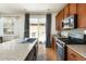 Close-up of kitchen island featuring stainless steel appliances, hardwood floors, and patio access at 3567 E 140Th Dr, Thornton, CO 80602