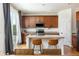 Spacious kitchen featuring wooden cabinets, quartz countertops, an island, and access to the patio at 3567 E 140Th Dr, Thornton, CO 80602