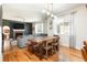 Combined living and dining area with hardwood floors and a brick fireplace at 3567 E 140Th Dr, Thornton, CO 80602