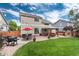 Expansive backyard with a well-maintained lawn, a patio with outdoor furniture, and a charming gazebo at 10245 Nottingham Dr, Parker, CO 80134