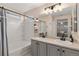 Bright bathroom showcasing a double vanity, a tiled bathtub, and a view into another room at 10245 Nottingham Dr, Parker, CO 80134