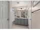 Bright bathroom featuring double sinks, modern lighting fixtures, and a neutral color scheme at 10245 Nottingham Dr, Parker, CO 80134