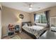 Bright bedroom featuring a ceiling fan, decorated with dinosaur themed bedding and a personalized wall decoration at 10245 Nottingham Dr, Parker, CO 80134