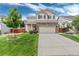 Charming two-story home with a brick facade, manicured lawn, and inviting curb appeal at 10245 Nottingham Dr, Parker, CO 80134