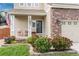 Inviting front porch with rocking chairs, lush landscaping, and an American flag at 10245 Nottingham Dr, Parker, CO 80134