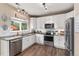 Modern kitchen with stainless steel appliances, white cabinets, and granite countertops at 10245 Nottingham Dr, Parker, CO 80134
