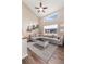 Bright living room with high ceilings, modern furniture, and a ceiling fan at 10245 Nottingham Dr, Parker, CO 80134