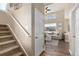 Staircase leading to a living room with tall ceilings and many windows for ample natural light at 10245 Nottingham Dr, Parker, CO 80134