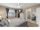 Spacious main bedroom with modern decor, a window, and a glimpse into the ensuite bathroom at 10245 Nottingham Dr, Parker, CO 80134