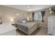 Comfortable main bedroom featuring a luxurious bed, soft lighting, and a window with views at 10245 Nottingham Dr, Parker, CO 80134