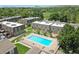 Aerial view showcases the community pool, well-kept grounds, and townhouse exteriors at 1517 S Owens St # 5, Denver, CO 80232