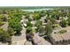 Aerial view of a residential area with mature trees and lake in the background at 1517 S Owens St # 5, Denver, CO 80232