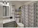 Stylish bathroom with granite vanity, framed mirror and decorative shower curtain at 1517 S Owens St # 5, Denver, CO 80232