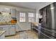 Bright kitchen features stainless steel appliances, tile floors, and access to the outdoors at 1517 S Owens St # 5, Denver, CO 80232