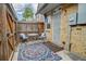 Private patio with cozy seating and a vibrant outdoor rug at 1517 S Owens St # 5, Denver, CO 80232