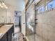Bathroom featuring large tiled shower with glass door and window, opening to main bedroom at 5188 Andes Way, Denver, CO 80249