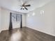 Empty bedroom with hardwood floors, a ceiling fan, and a bright window at 5188 Andes Way, Denver, CO 80249
