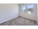 Bedroom featuring neutral carpet and natural light from two windows at 5188 Andes Way, Denver, CO 80249