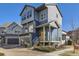 Modern two-story home featuring blue siding, a covered porch, and an attached garage at 5188 Andes Way, Denver, CO 80249