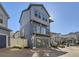 Modern two-story home featuring blue siding, a small balcony, and an attached garage at 5188 Andes Way, Denver, CO 80249