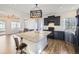 Modern kitchen boasts granite counters, dark cabinets, and a large central island at 5188 Andes Way, Denver, CO 80249