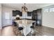 Stylish kitchen featuring dark cabinets, granite counters, and a central island with seating at 5188 Andes Way, Denver, CO 80249