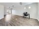 Open-concept living room with luxury vinyl floors, sliding glass door, and office nook at 5188 Andes Way, Denver, CO 80249