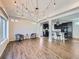 Open concept living area features modern lighting and flows into a sleek, modern kitchen at 5188 Andes Way, Denver, CO 80249