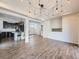 Open concept living space flows into kitchen with sleek cabinets and granite countertops at 5188 Andes Way, Denver, CO 80249