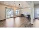 Spacious living room features hardwood floors, large windows, and stylish modern lighting at 5188 Andes Way, Denver, CO 80249