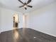 Spacious main bedroom featuring hardwood floors, ceiling fan, and ensuite bathroom access at 5188 Andes Way, Denver, CO 80249