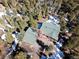 Stunning aerial view of mountain home nestled amongst mature pine trees with snow on the ground at 11540 Inspiration Rd, Golden, CO 80403