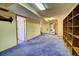 Basement featuring blue carpet, stairs to the upper level, and a laundry area at 11540 Inspiration Rd, Golden, CO 80403