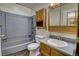 Bathroom with updated vanity, medicine cabinet, toilet, and shower-tub combination at 11540 Inspiration Rd, Golden, CO 80403