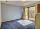 Bedroom featuring blue carpet, neutral walls, and a sliding glass door to the outside at 11540 Inspiration Rd, Golden, CO 80403