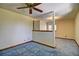 Bedroom with blue carpet, neutral walls, a ceiling fan, and an open floor plan at 11540 Inspiration Rd, Golden, CO 80403