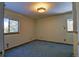Bedroom with blue carpet, neutral walls, a ceiling light, and two windows for natural light at 11540 Inspiration Rd, Golden, CO 80403