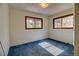 Bedroom featuring natural light from two windows and comfortable blue carpet at 11540 Inspiration Rd, Golden, CO 80403