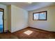A sunlit bedroom featuring one window, neutral walls, and warm colored carpet at 11540 Inspiration Rd, Golden, CO 80403