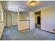 Bedroom featuring carpet flooring, neutral walls, ceiling fan, wood trim, and access to other rooms at 11540 Inspiration Rd, Golden, CO 80403