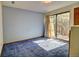 Bedroom featuring sliding glass doors, carpet flooring, neutral walls, and a ceiling light fixture at 11540 Inspiration Rd, Golden, CO 80403