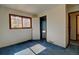 A sunlit bedroom featuring one window, neutral walls, and comfortable blue carpet at 11540 Inspiration Rd, Golden, CO 80403