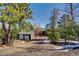 A cozy home exterior with two car garage among the trees at 11540 Inspiration Rd, Golden, CO 80403