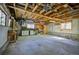 Spacious garage with exposed beams, cabinets, and workbenches at 11540 Inspiration Rd, Golden, CO 80403